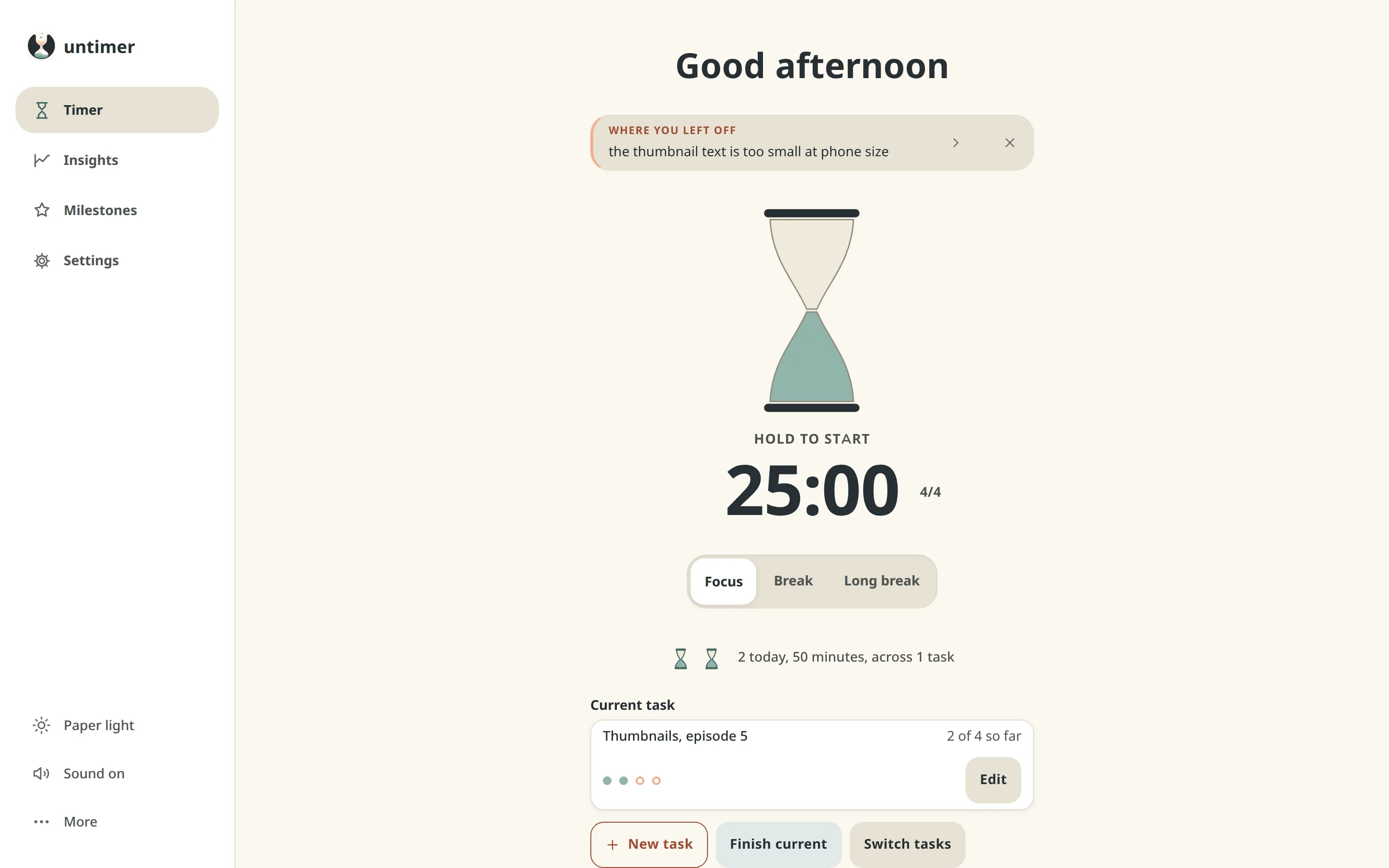 The Timer screen of Untimer: a greeting, the message box under it showing a line written at the last interruption, the hourglass at rest with Hold to start under it, 25:00, the set figure 4/4, a Focus, Break and Long break selector, two small hourglasses for the two sessions of the day so far, and the current task, Thumbnails episode 5, at two of four sessions.
